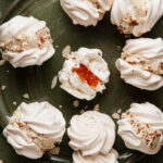 Almond meringue cookies filled with whipped cream and preserves.