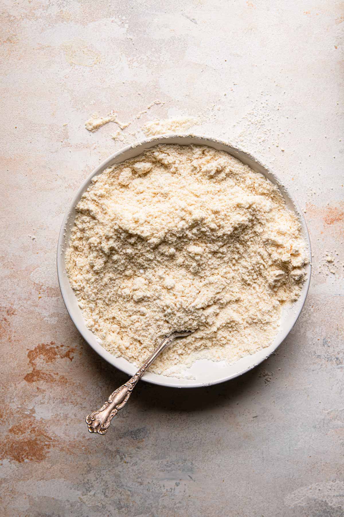A bowl with almond flour and a fork.