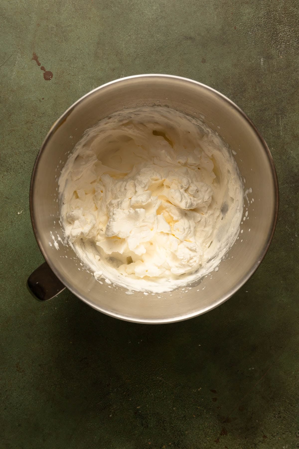 Whipped cream in a mixer bowl.