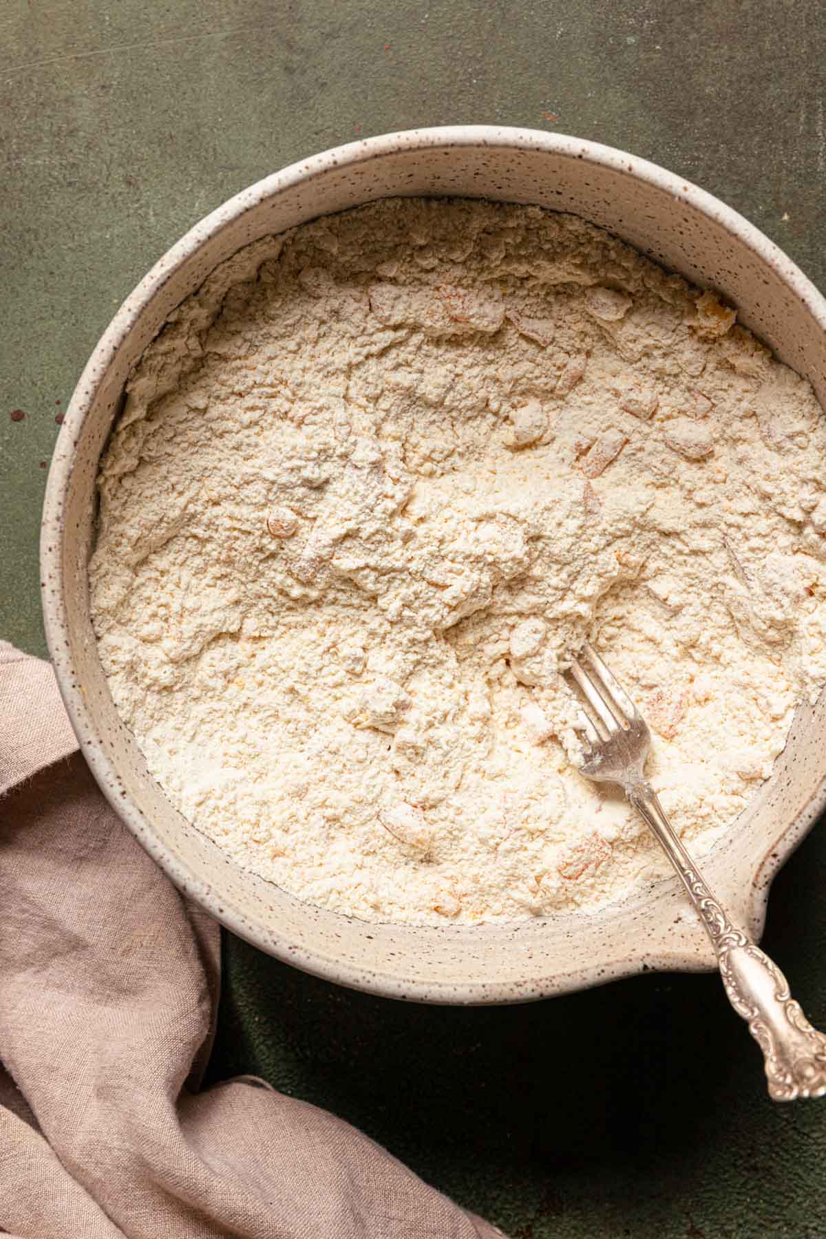A bowl with flour mixture and a fork.