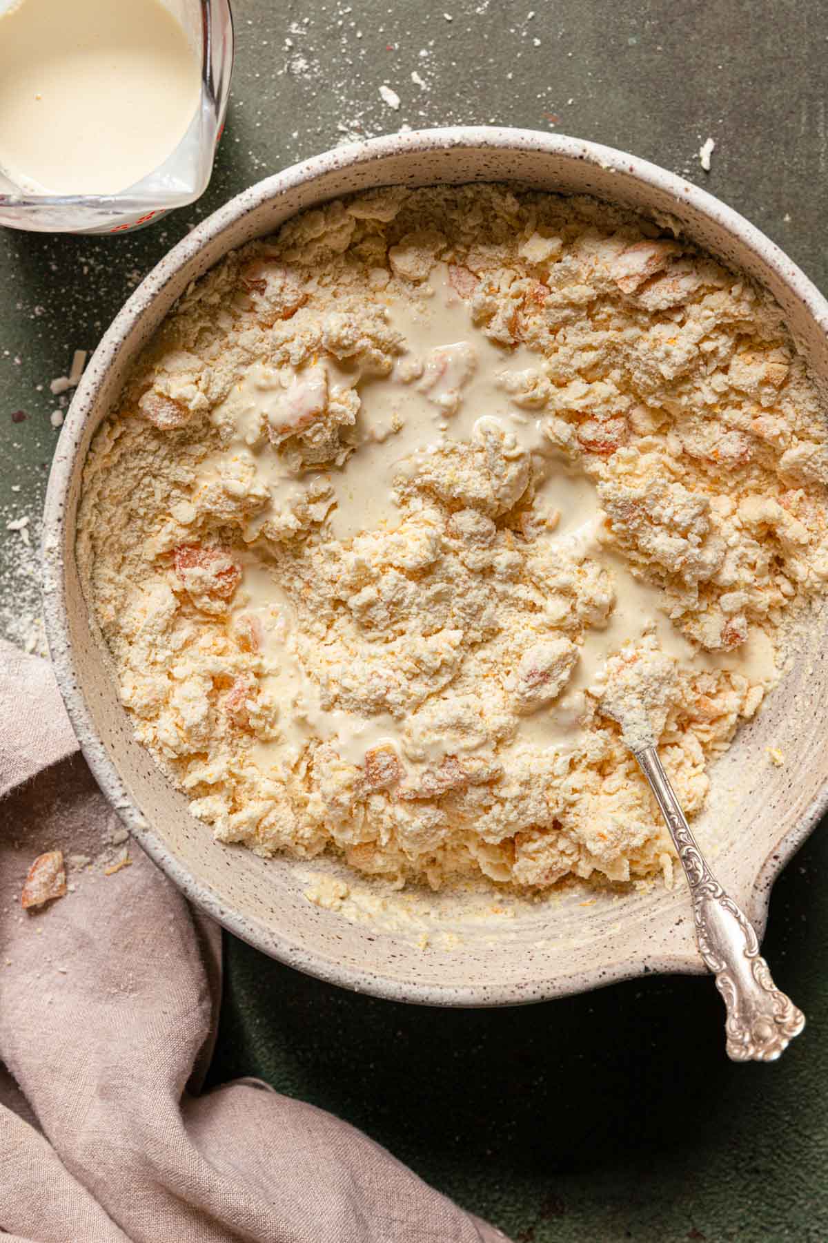 A bowl with flour and heavy cream. A measuring cup next to it.