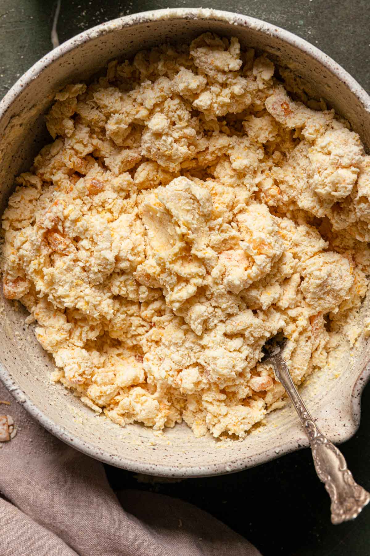 A bowl with clumps of dough.