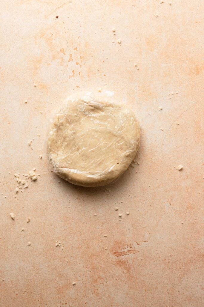A pie dough in a plastic wrap.