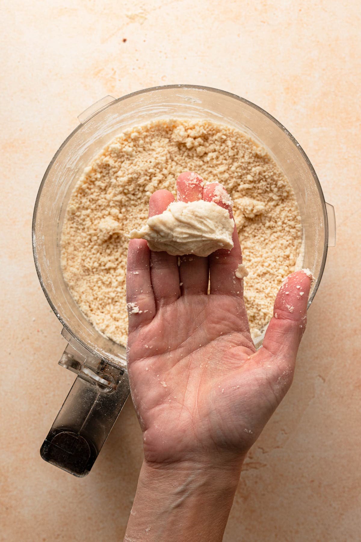 A hand pressing dough.