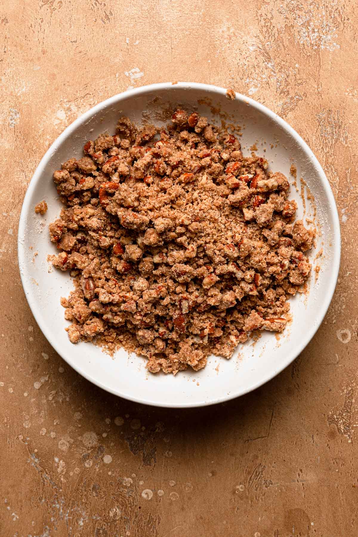 A bowl with pecan cinnamon streusel.