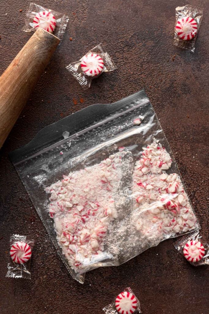 A bag with crushed candy cane and a rolling pin.
