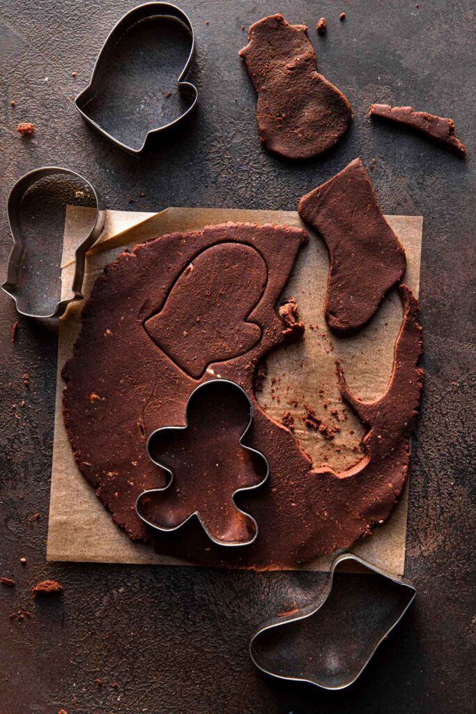 Chocolate dough cut with christmas cookie cutters.