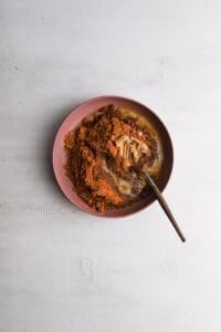Ciscoff crumbs, brown sugar and melted butter in a bowl with a fork