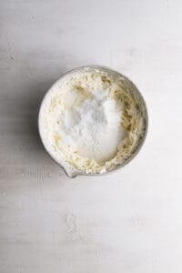 A bowl with cream cheese mixture and sugar