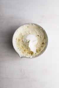 A bowl with cream cheese sugar mixture and sour cream