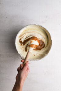 Melted biscoff butter folded into cheesecake mixture