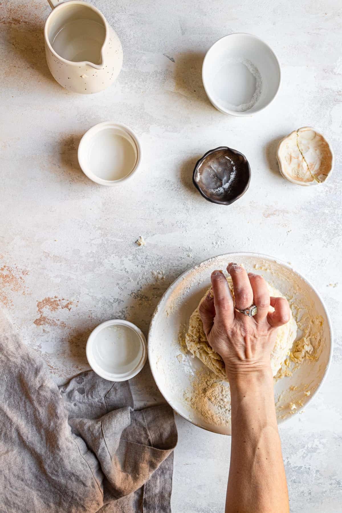 A hand kneading dough.