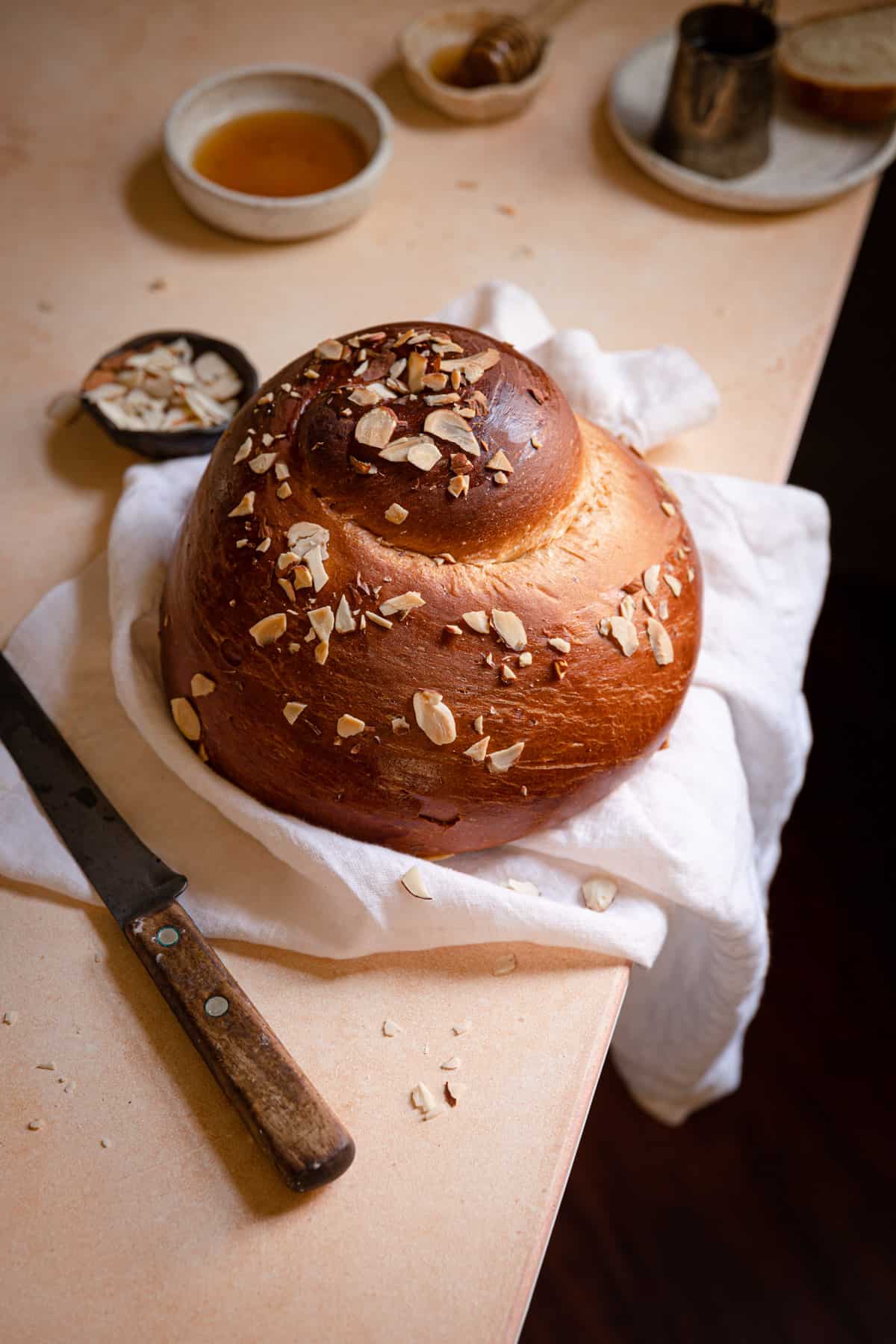 round Challah with a knife next to it