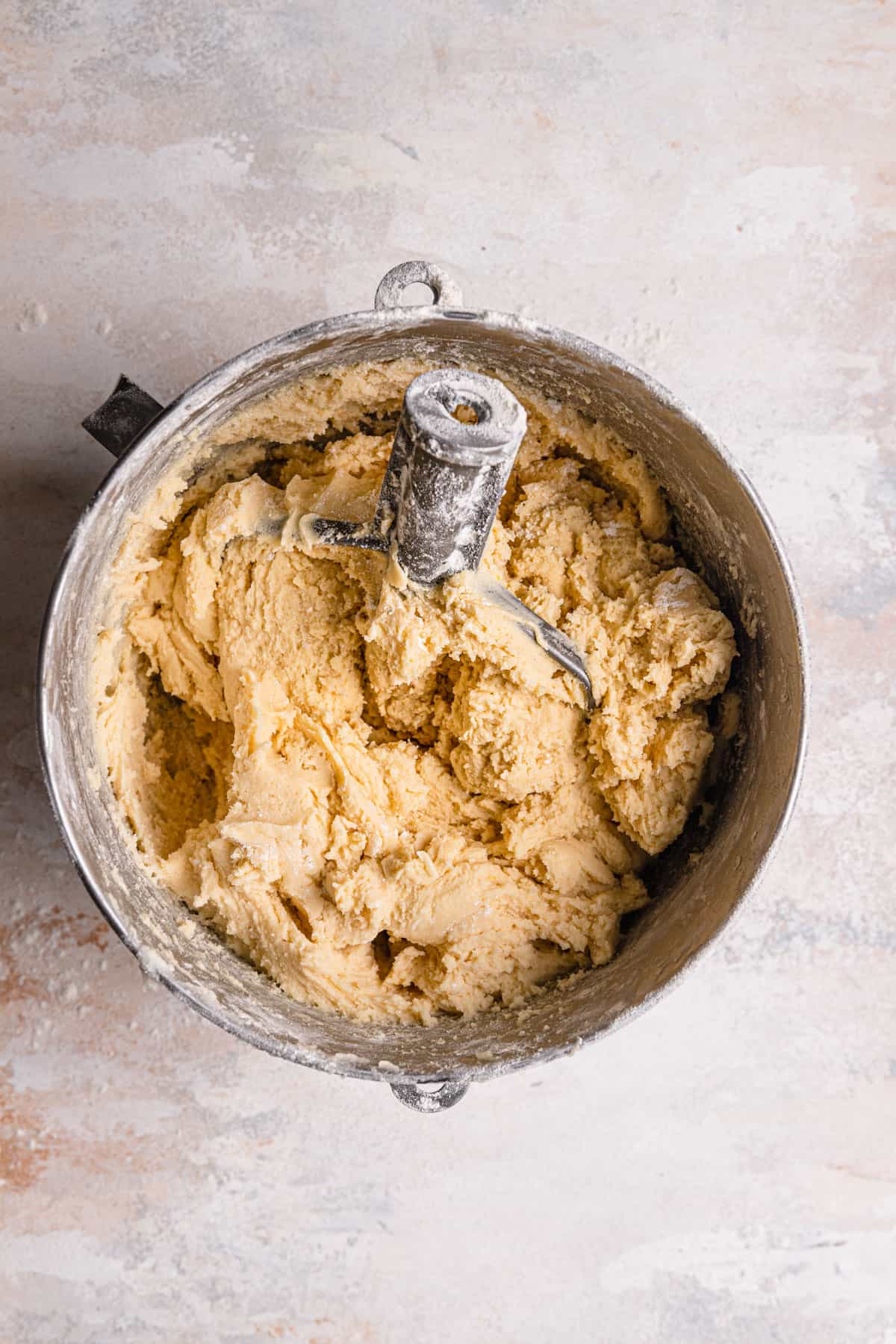 A mixing bowl with smooth cookie dough and the paddle attachment.
