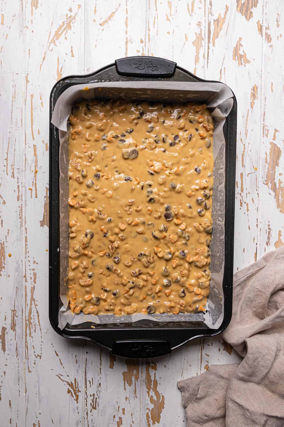 A brownie pan with unbaked buttercotch blondie batter.