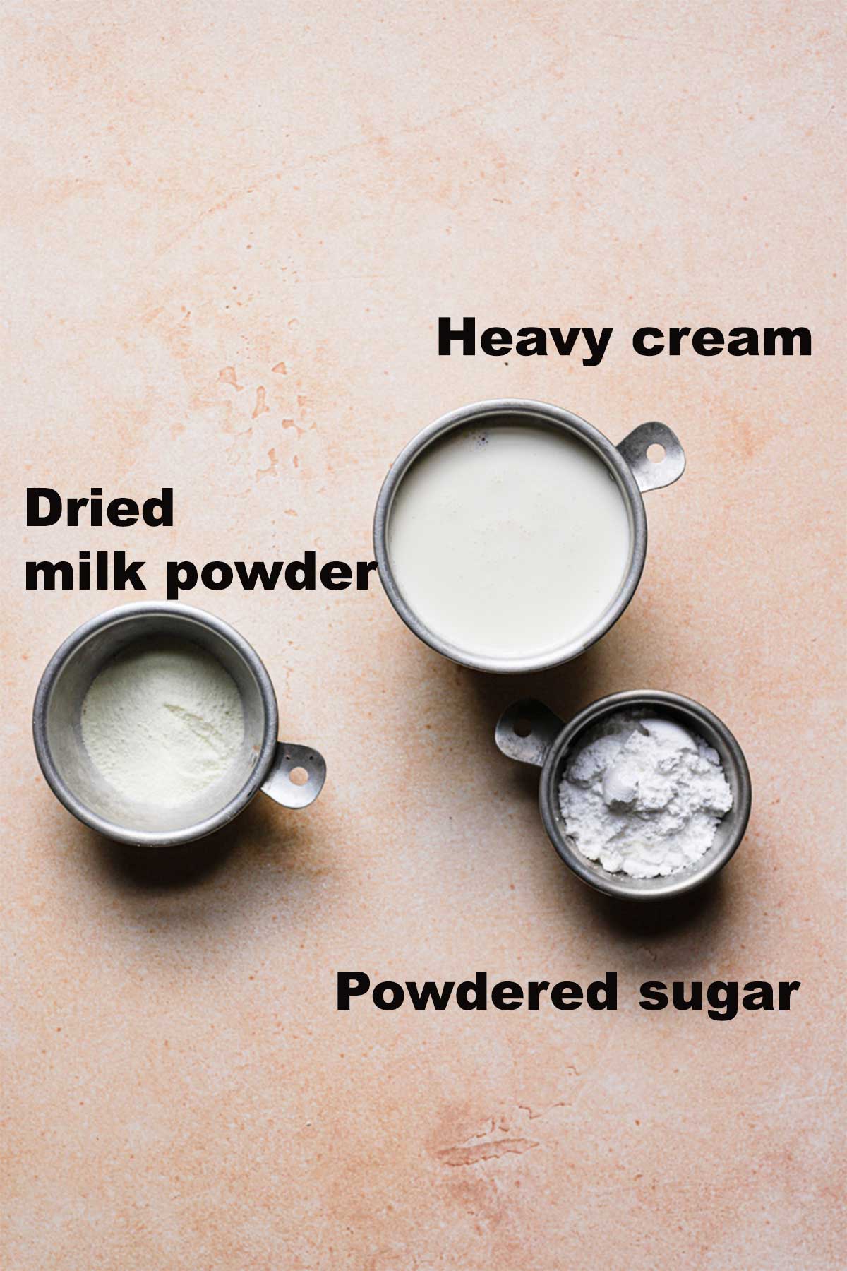 Ingridietns list to for a stabilized heavy cream you can pipe on cupcakes or frost a cake with: dried milk powder, heavy cream and powdered sugar
