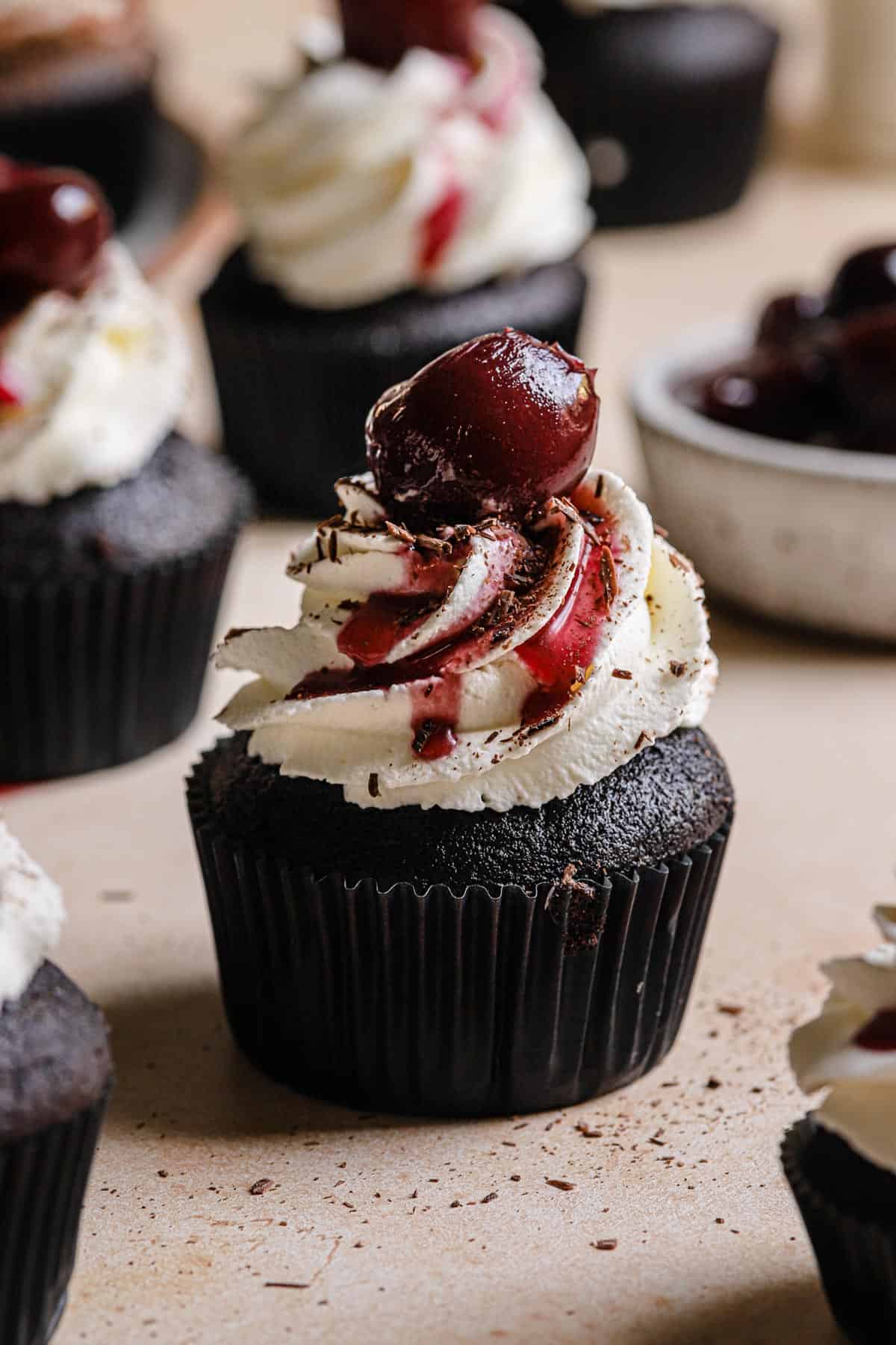 Chocolate cupcake filled with cherry filling and topped with whipped heavy cream