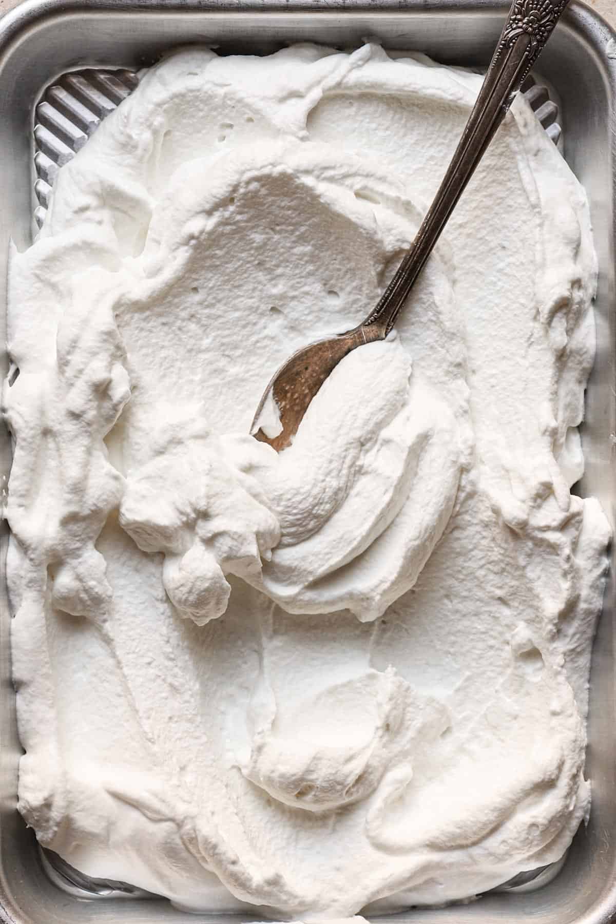 stabilized whipped cream in a pan and a spoon.