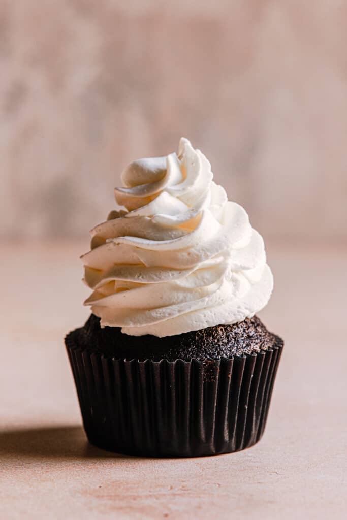 chocolate cupcakes topped with stabilized heavy cream