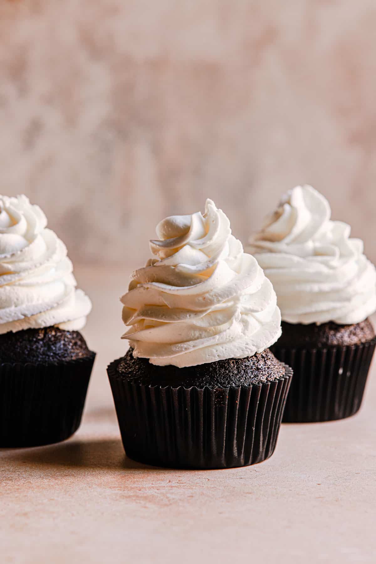 chocolate cupcakes topped with heavy whipped cream