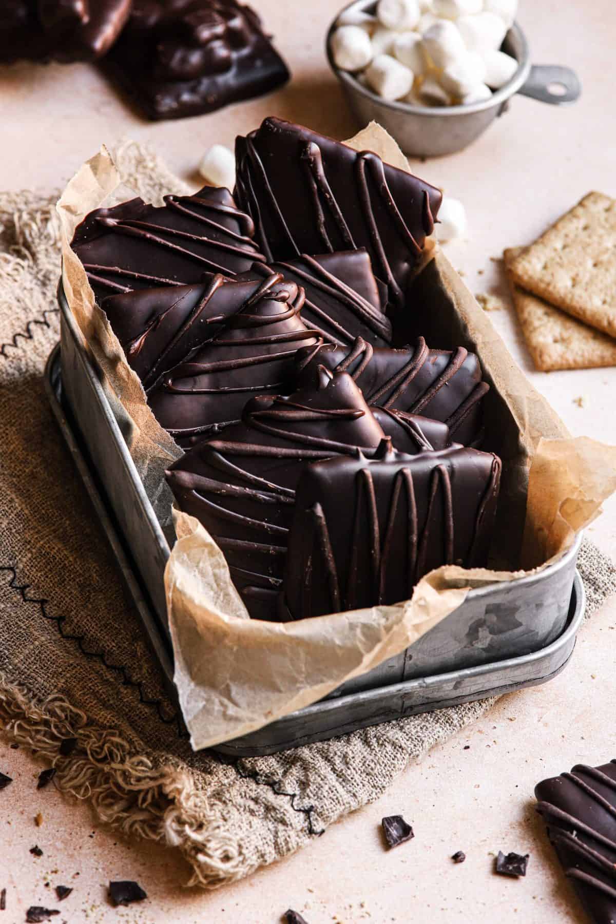 Chocolate dipped graham crackers in a container