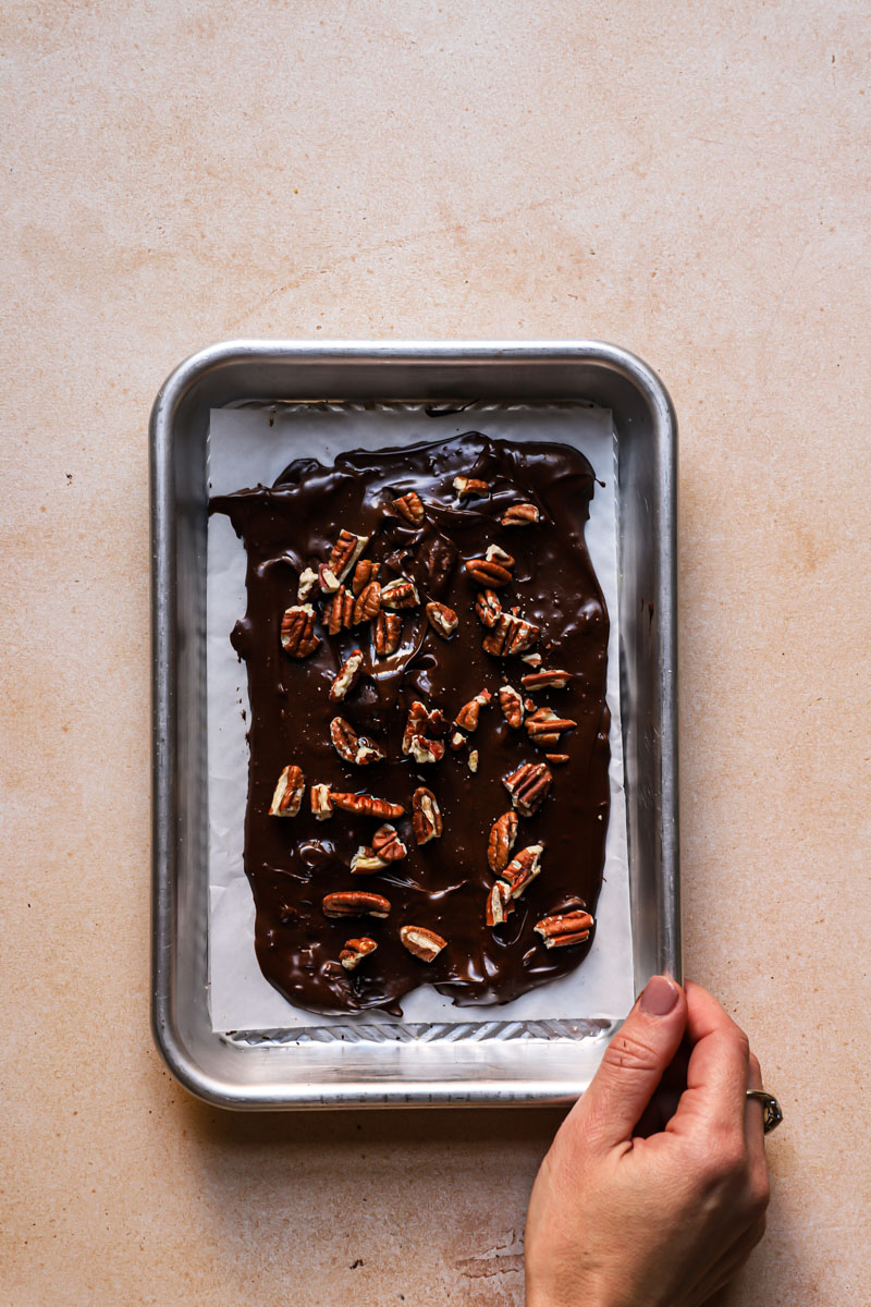 Chocolate pecan bark in a pan.