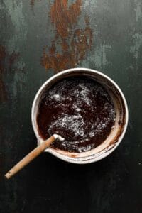 A bowl with brownies mixture and folded flour