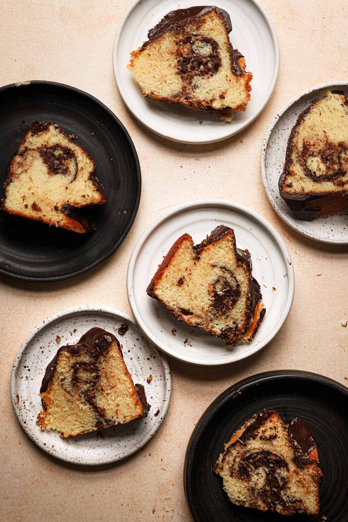 almond cake slices swirled with melted chocolate in plates.