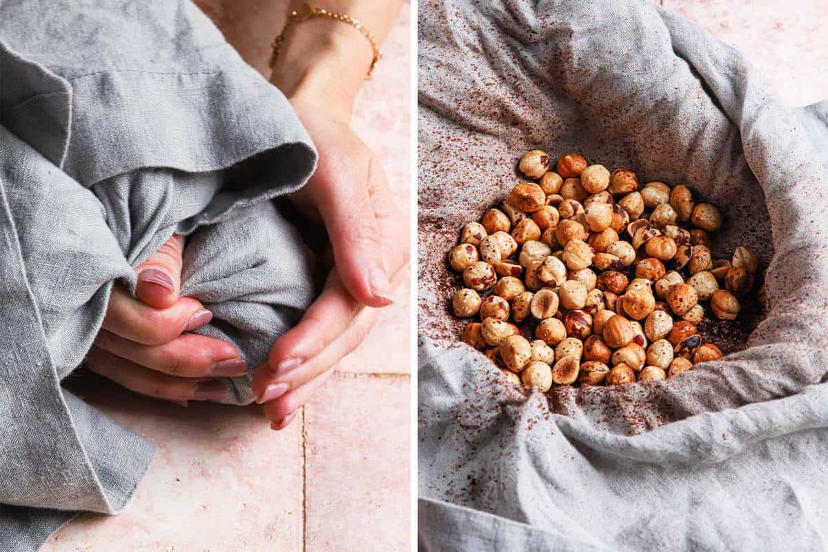 a hand rubbing warm hazelnuts in a kitchen towel to remove skin