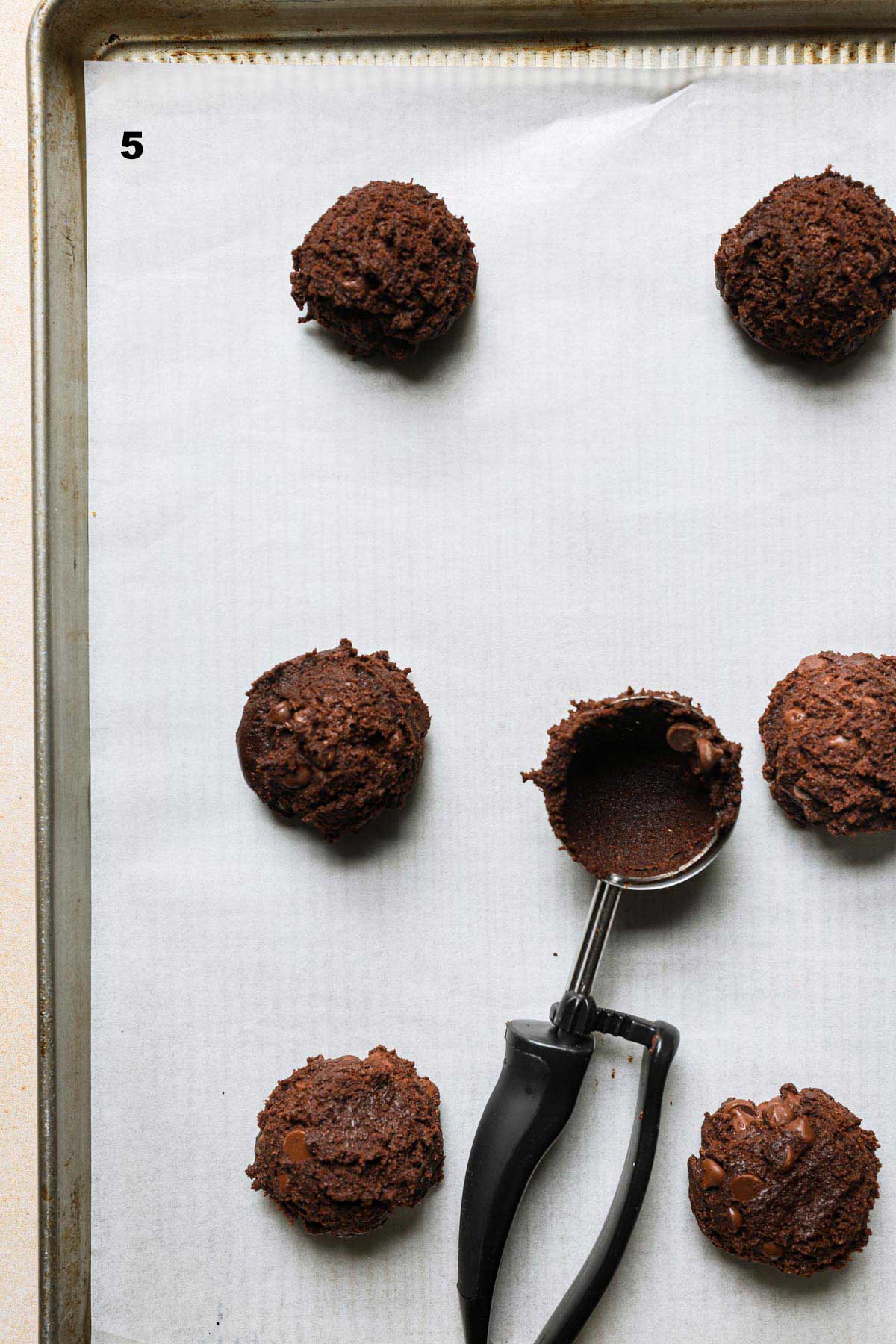 Cookie sought scooped on a cookie sheet.