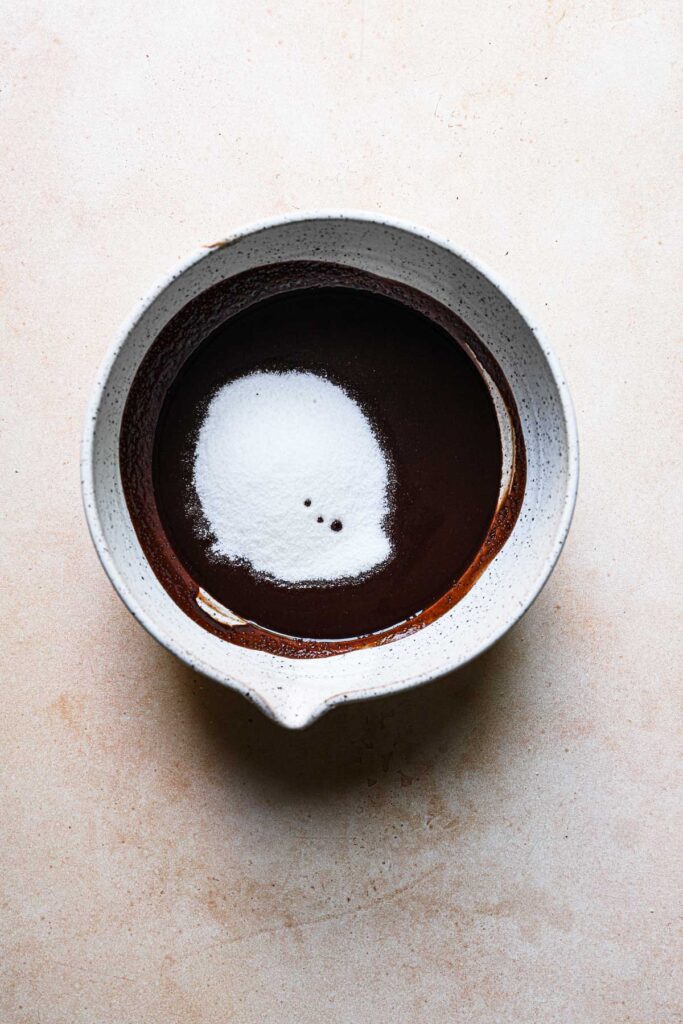 A bowl with melted chocolate mixture and suagr.