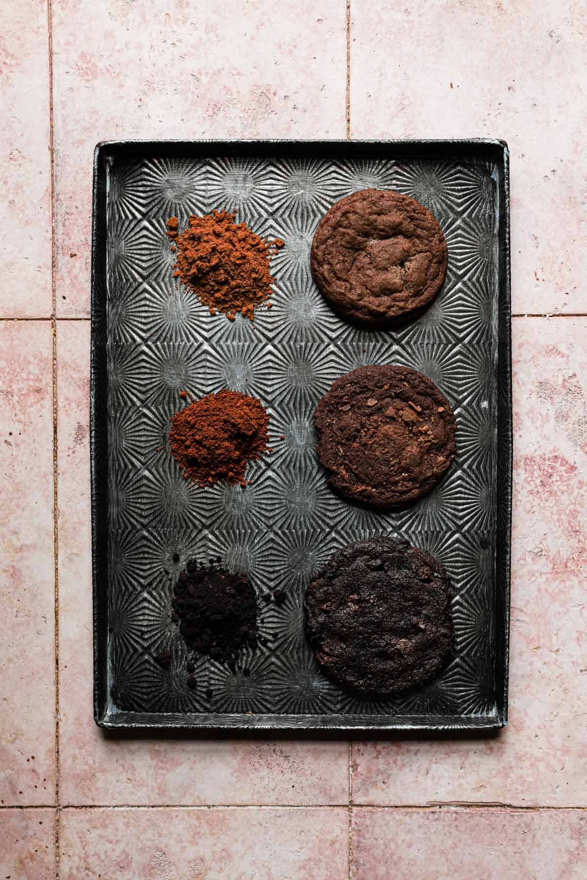 Three chocolate cookies, each baked with a different type of cocoa powder