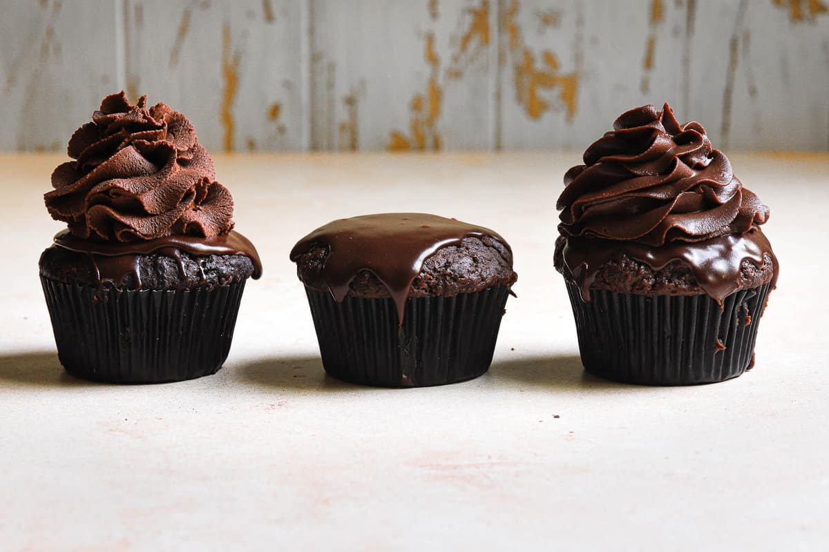 chocolate cupcakes frosted with types of frosting.