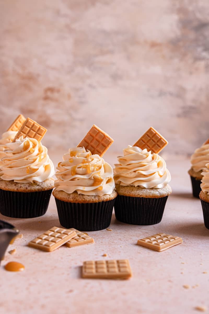 frosted cupcakes with a mini chocolate bars on top.