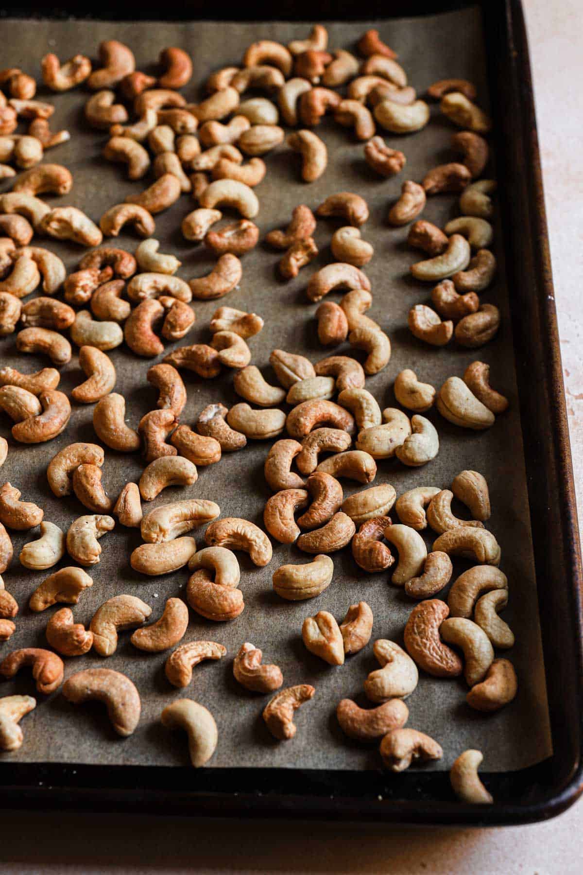 Roasted cashews in a baking pan