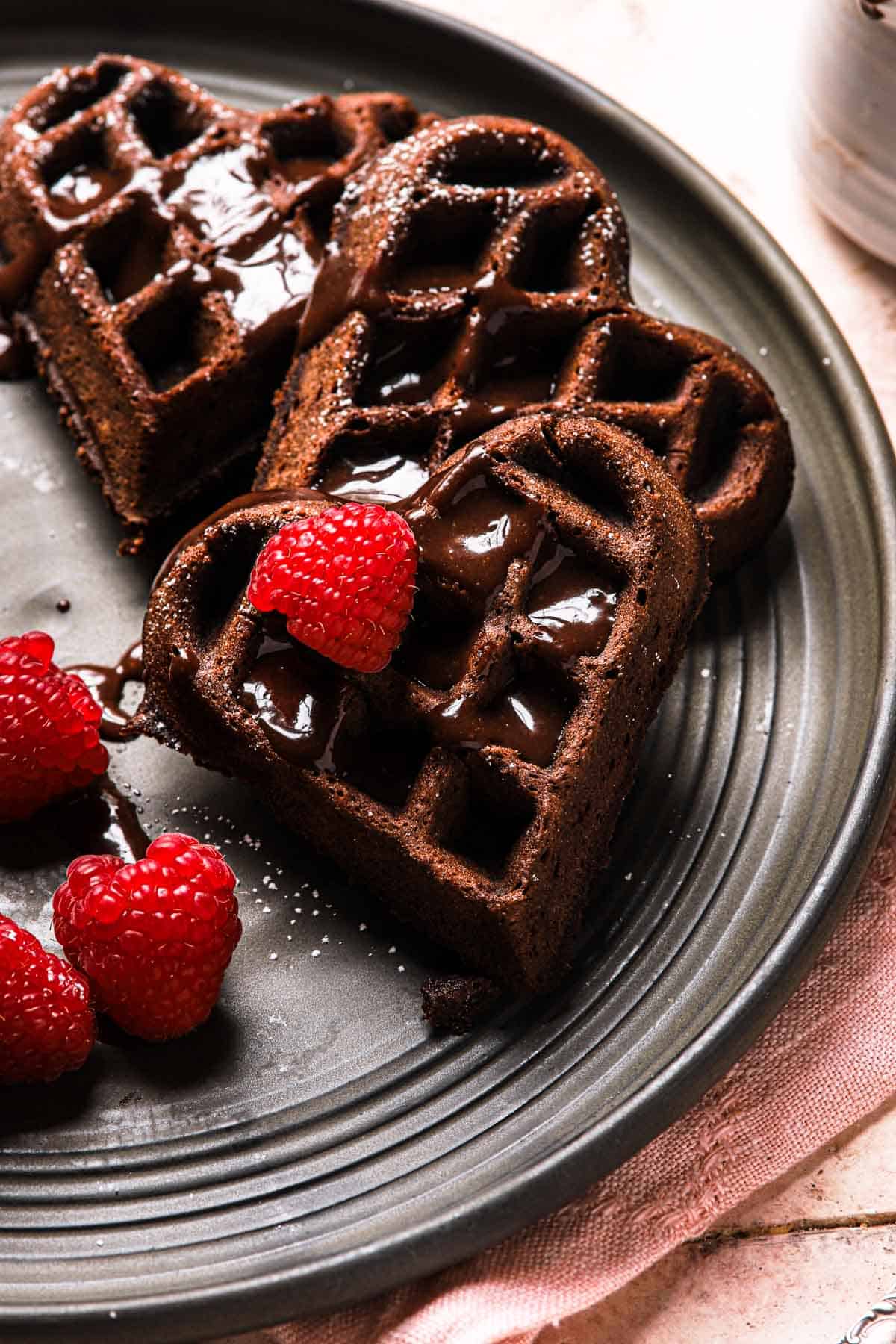 waffles with chocolate sauce and raspberries