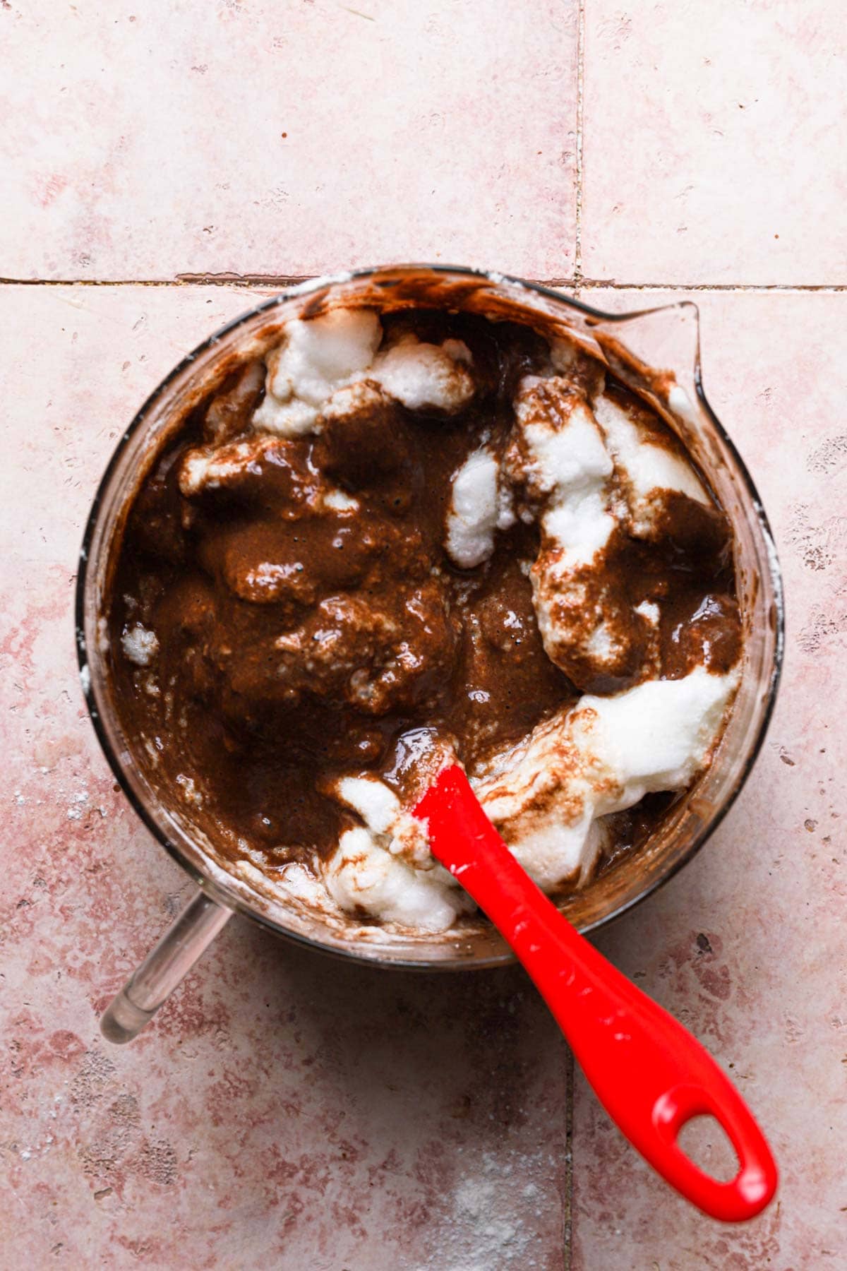 A bowl with meringue folded into chocolate batter