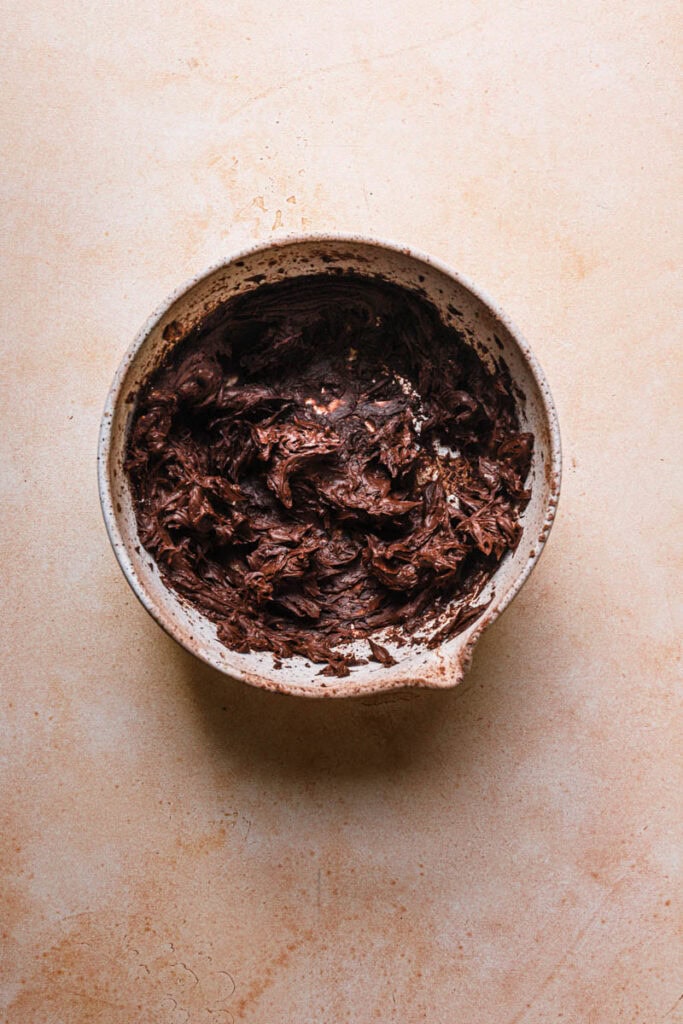 A mixing bowl with chocolate cream.