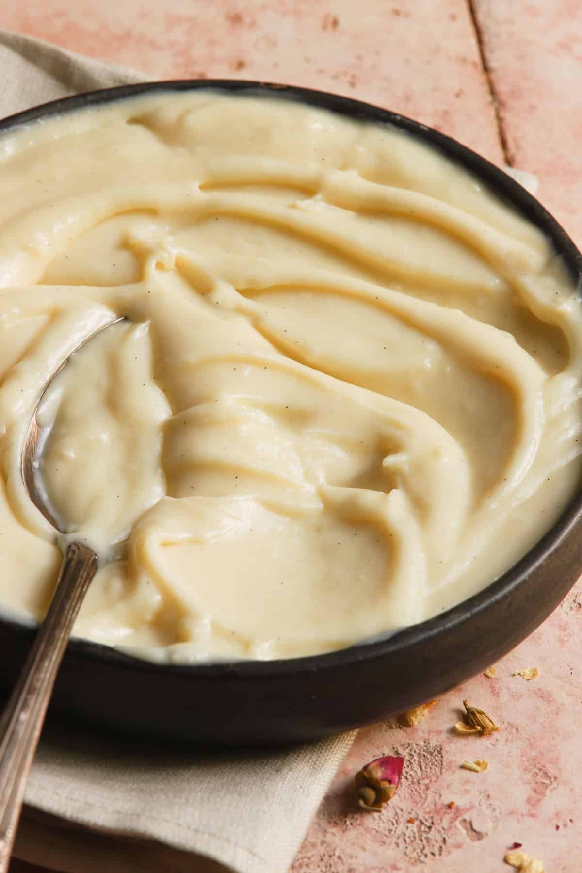 pastry cream in a bowl with a spoon.