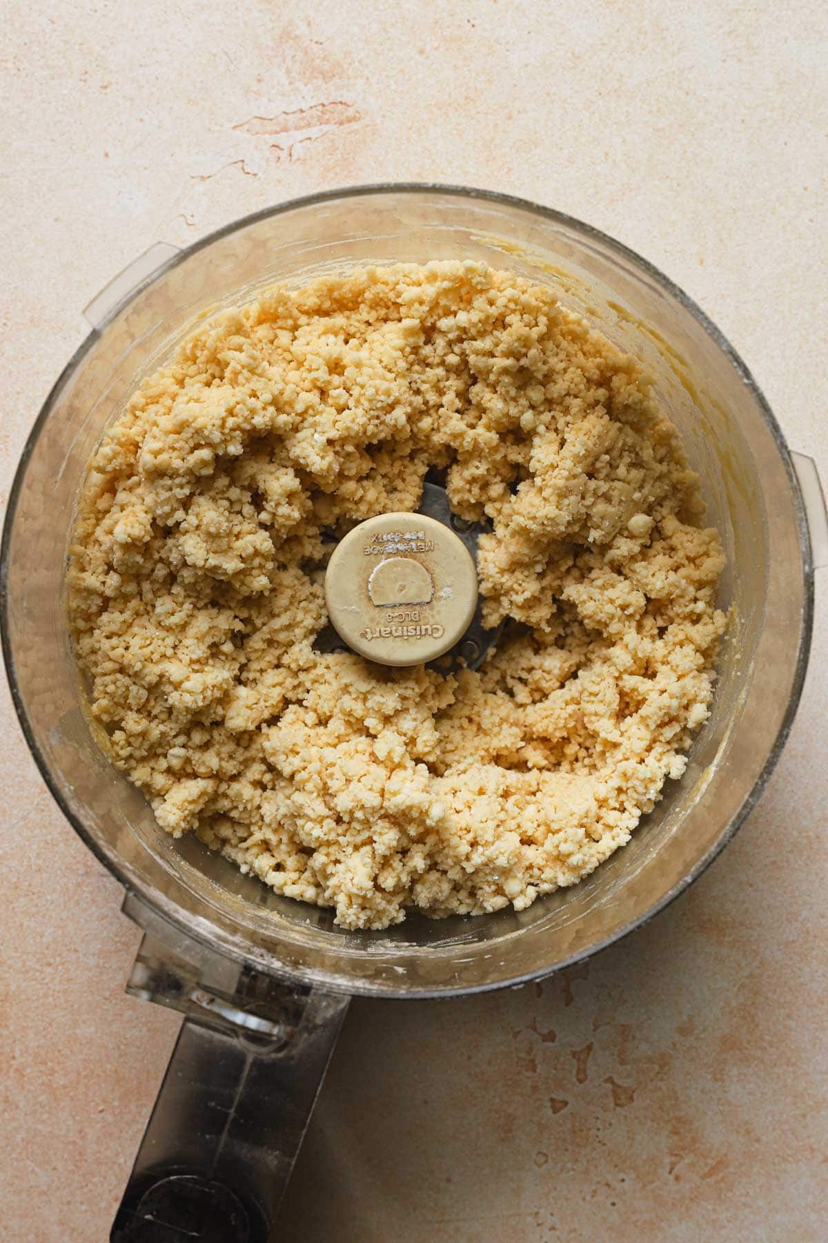 A food processor with shortcrust pastry dough.