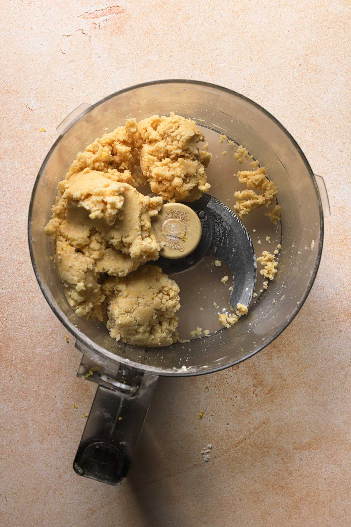 A food processor bowl with dough.