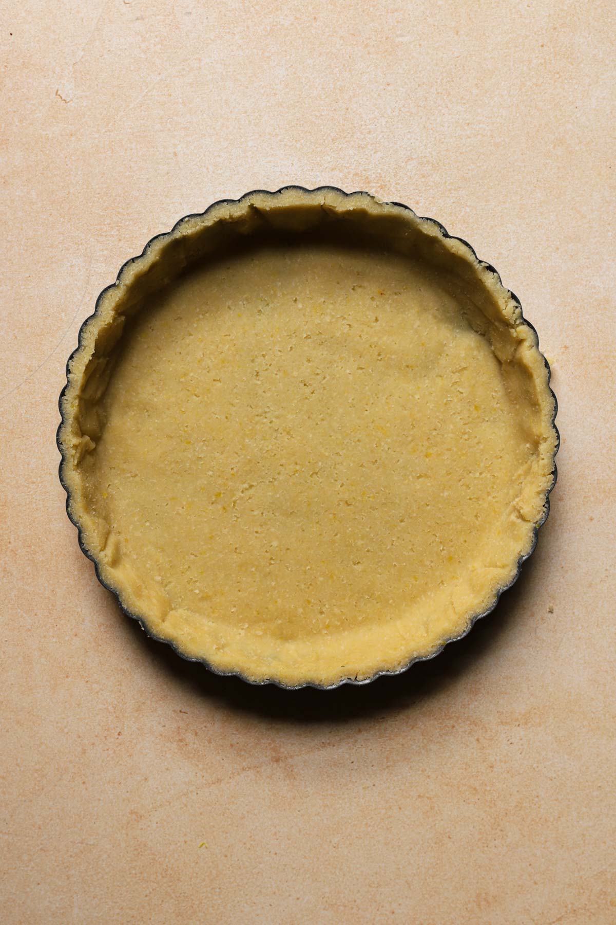 A tart pan lined with dough.
