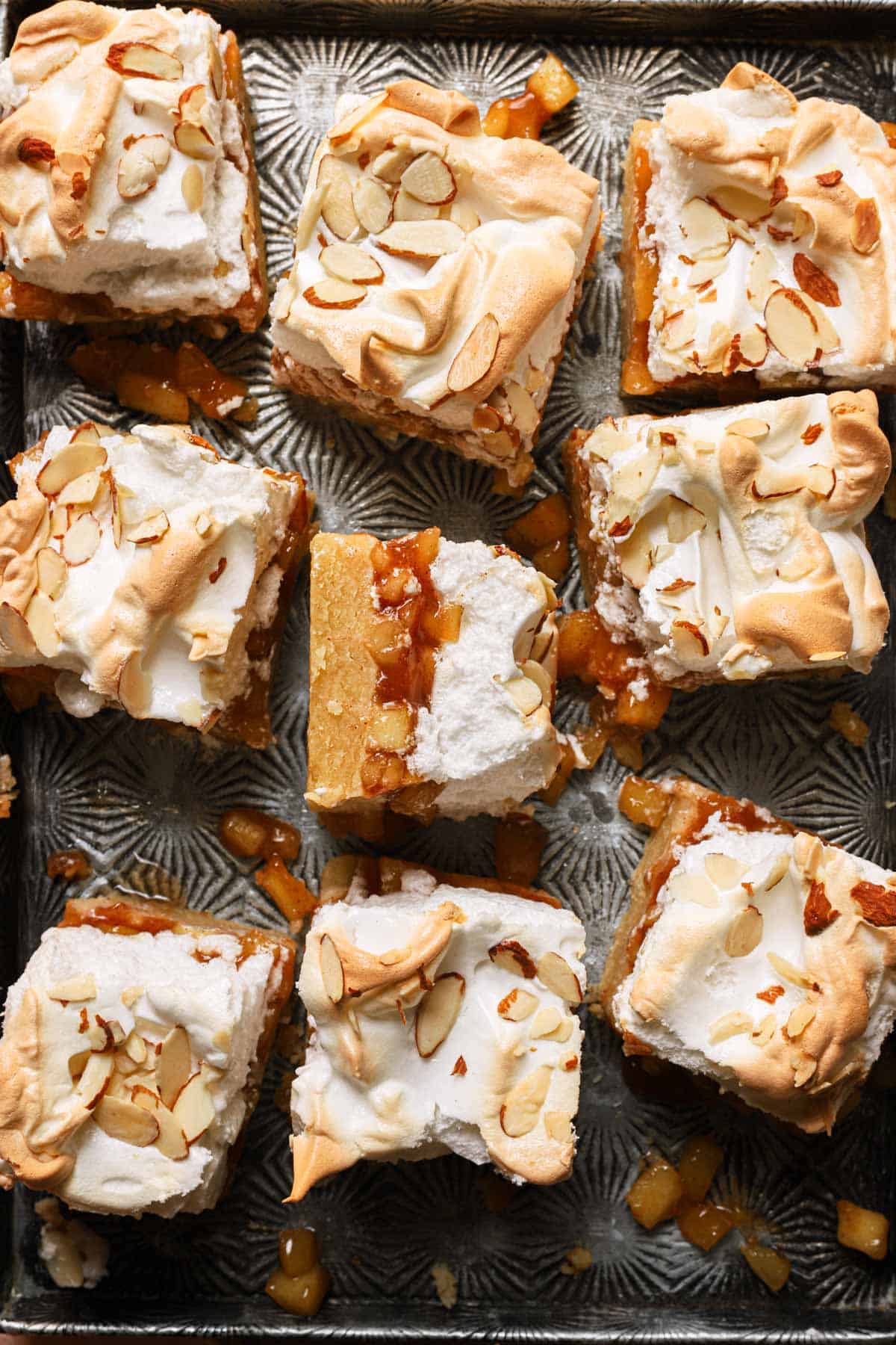 Apple bars topped with meringue and almonds.