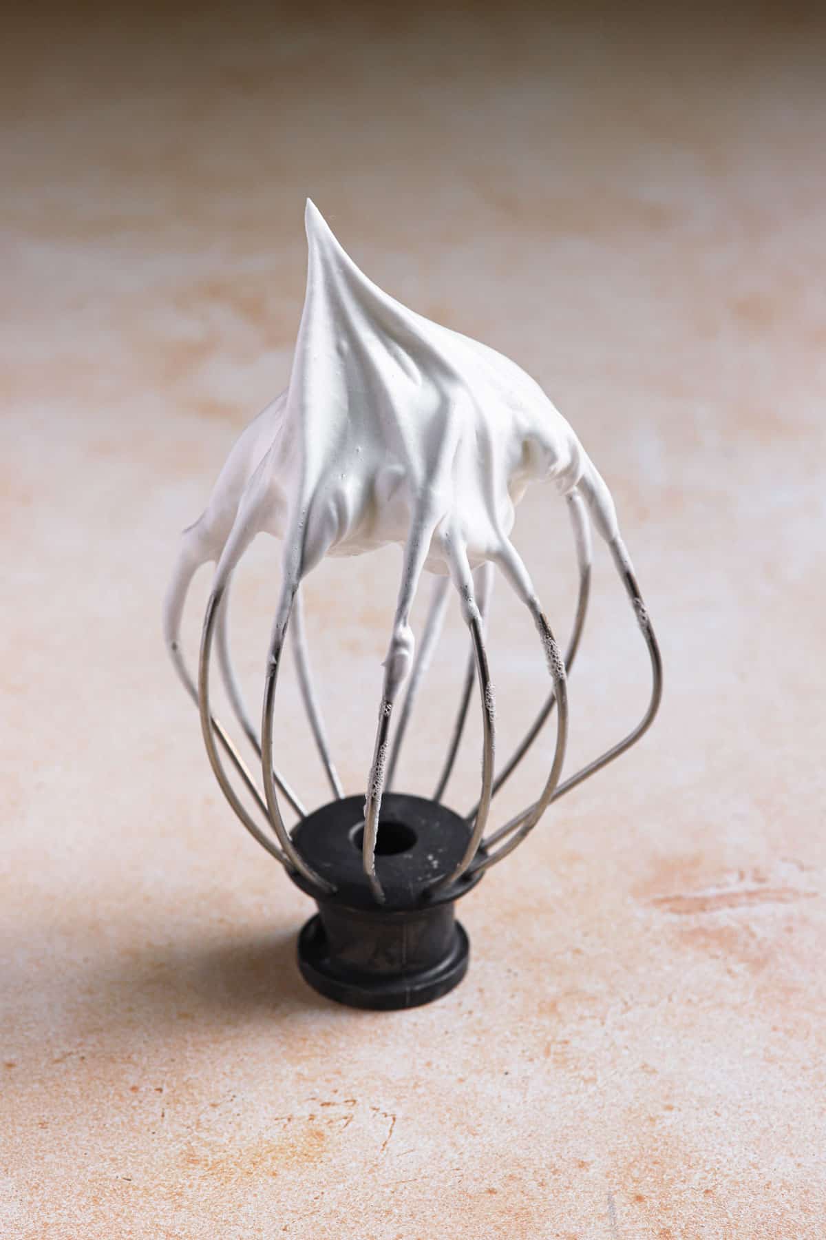 Stiff peak meringue on a whisk