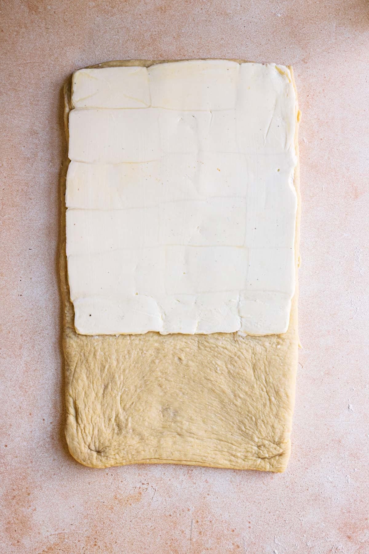 Rolled dough topped with butter block.
