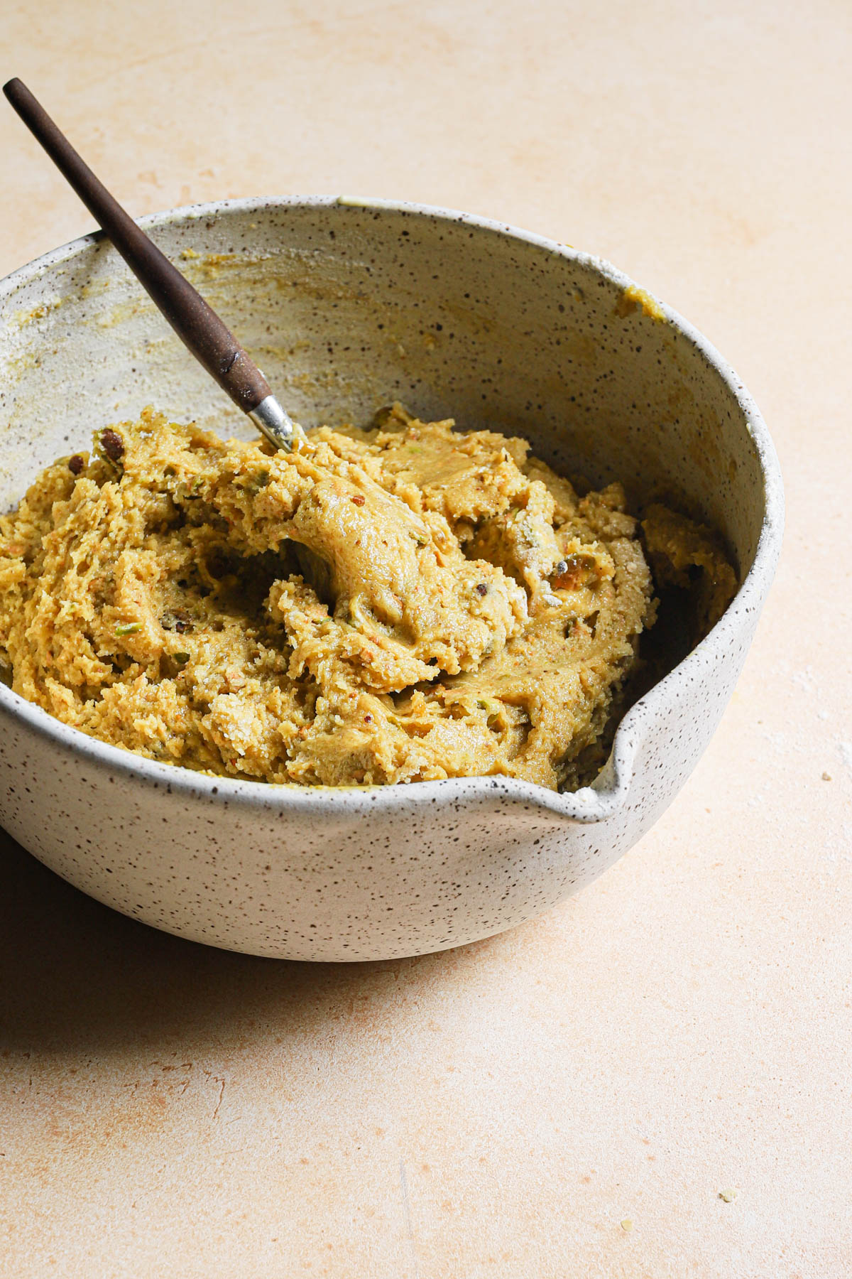 Muffin batter in a bowl with a spoon.