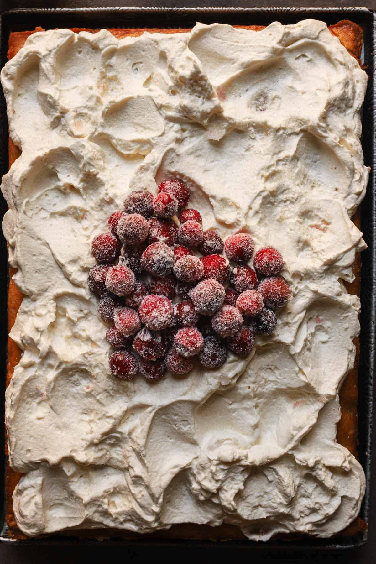 cake topped with sugared cranberries