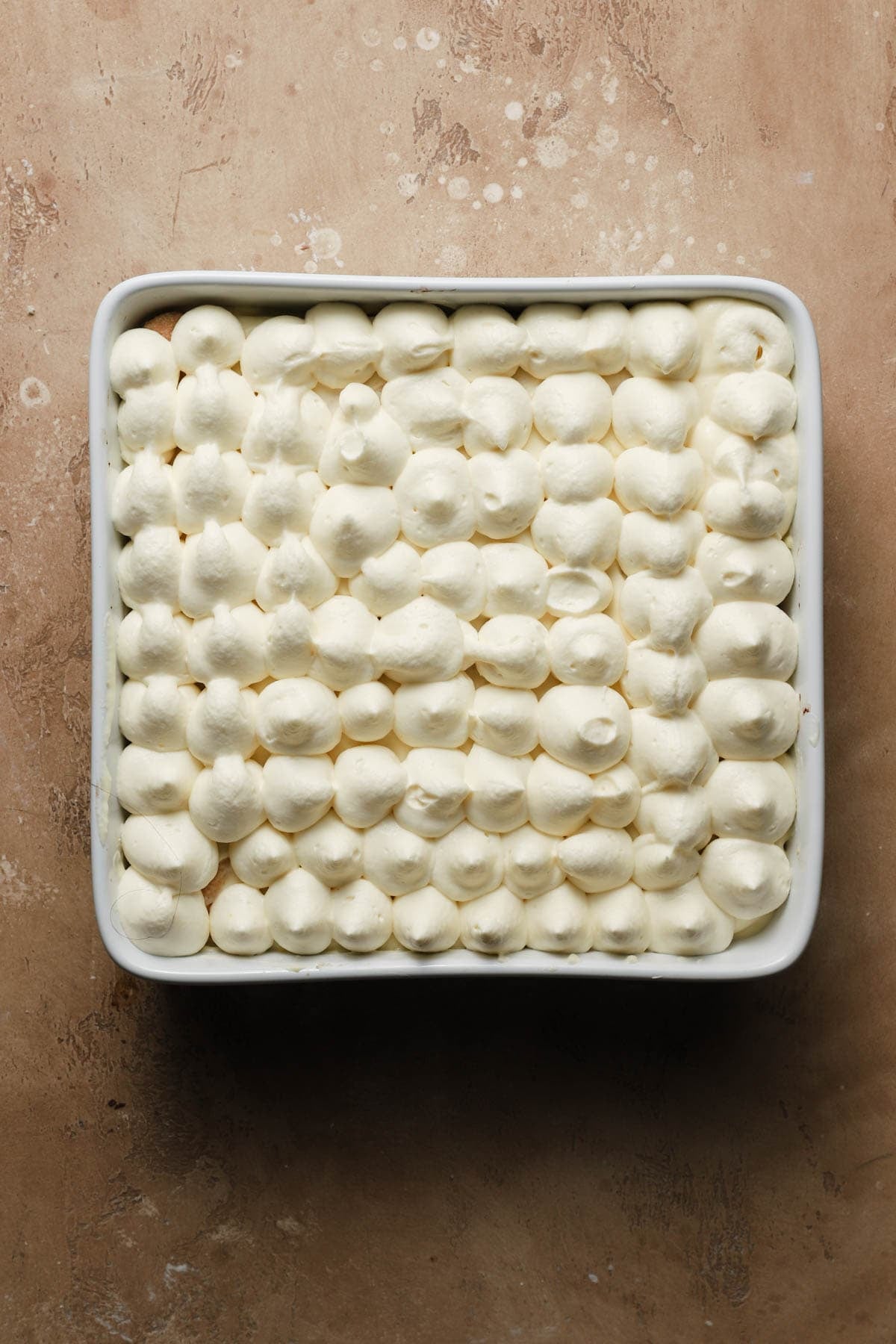 Tiramisu topped with cream.