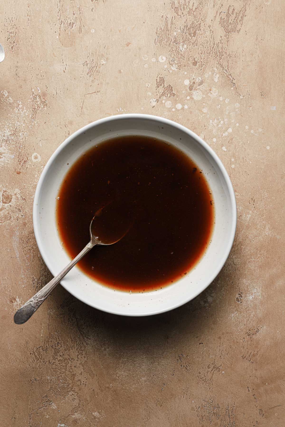 a wide bowl with coffee and a spoon.