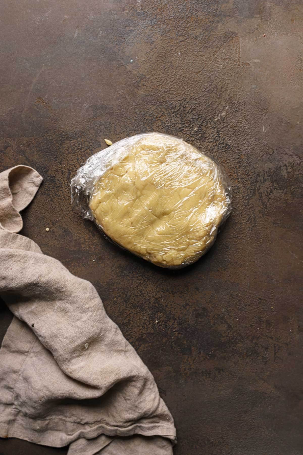Pasta frolla wrapped in plastic wrap.
